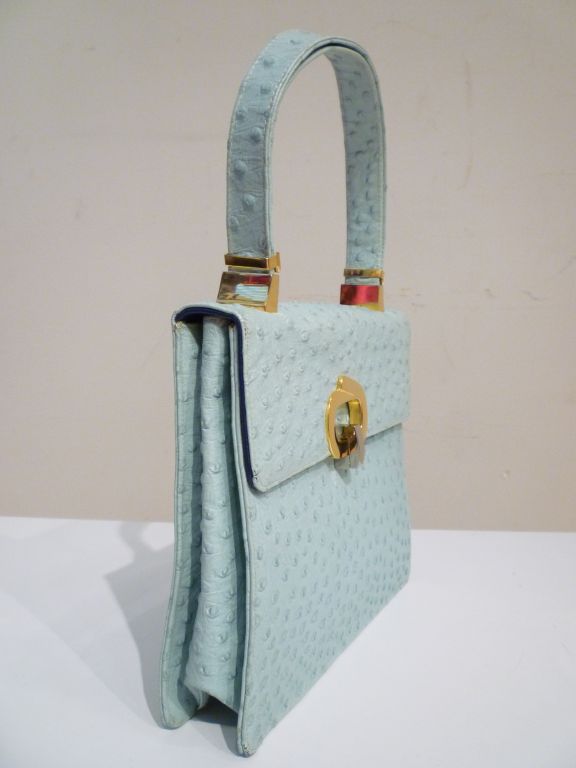 Fabulous mint condition Koret baby blue leather embossed in an ostrich texture with gold hardware.  Interior is royal blue leather with pockets lined in gold faille and lavender taffeta.  Original attached leather coin purse still intact.   <br