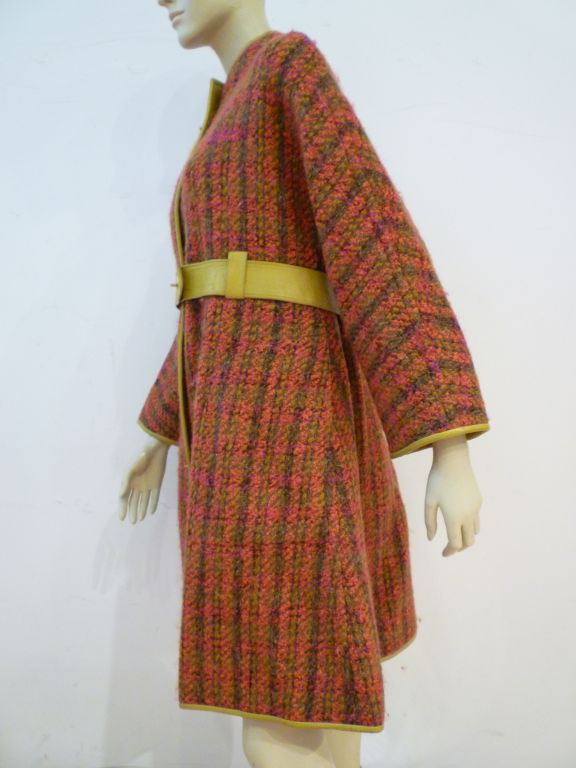 A fantastic Bonnie Cashin designed 60s Sills wool tweed coat in multicolor plaid, simple in design with metal toggle closures and edged and bound in chartreuse leather w/ matching leather belt.