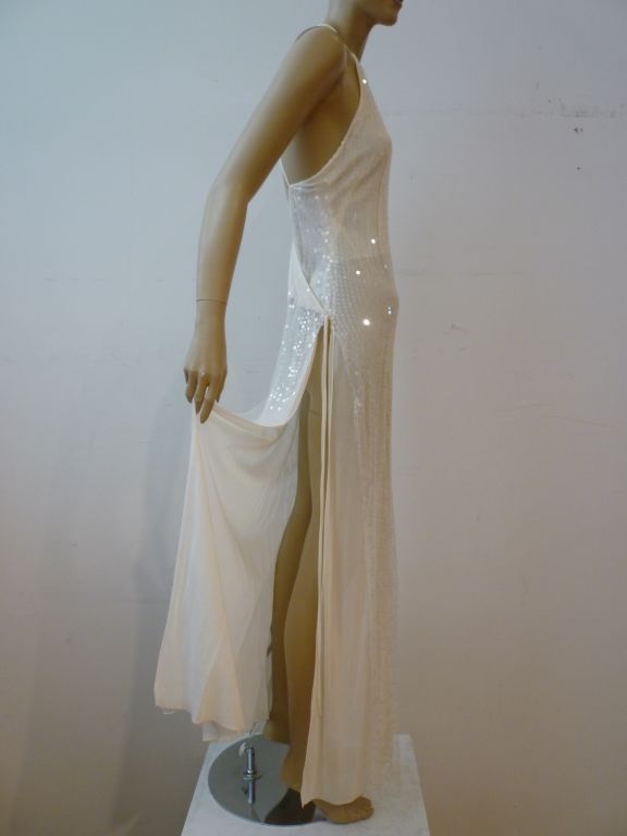 A beautiful and daring Chanel gown in diaphanous white with iridescent sequins. Halter cut front and deep cut back with cross straps and double 