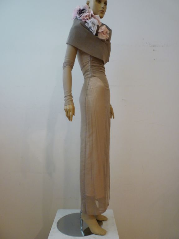 A fabulous 90s Dolce & Gabbana gown of ethereal gray cotton/lycra tulle incorporating corset boning at the waist, long sleeves and a huge tulle and buckram shawl collar adorned with silk flowers!  Marked an Italian size 40, this piece was an