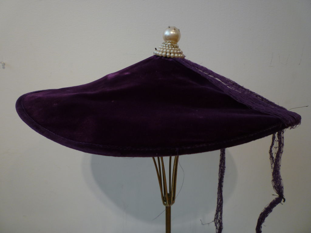 A wonderful 1950s purple velvet cocktail hat by Henry G. Ross with conical design and pearl peak!