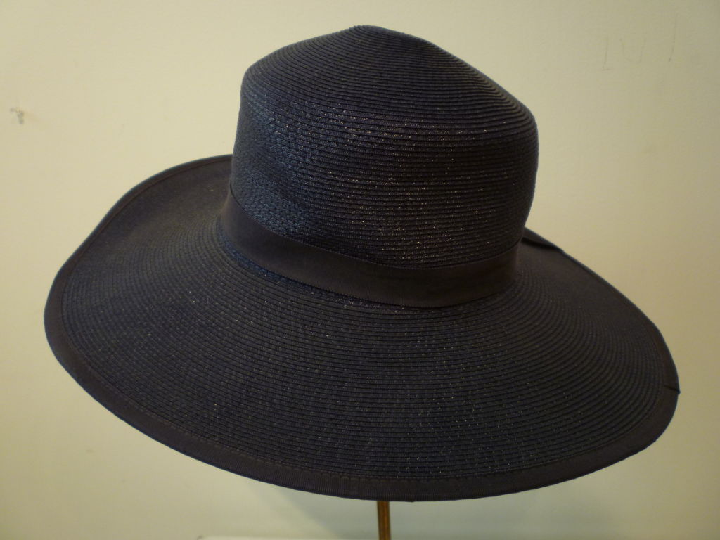 A great simple, classic 1950s/60s navy blue straw summer hat with wide brim and grosgrain band from The Paris Boutique!  Marked size 22.