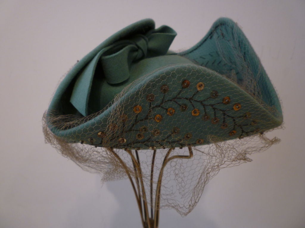 A great 1940s teal green felt tricorner style hat with embroidery and sequin trimming and veil.  Made by Germaine Montabert.