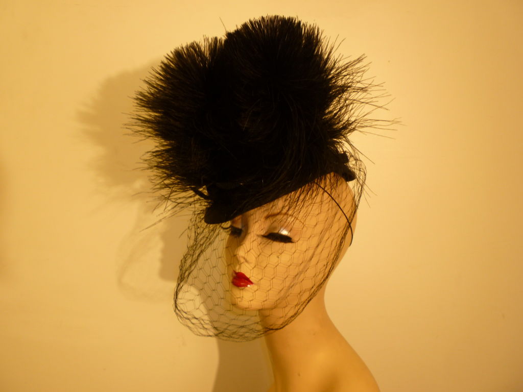 An incredibly collectible 1940s Bes-Ben black straw tilt hat with extravagant black egret feather plumes and perfect veil. This is a once-in-a-lifetime piece!