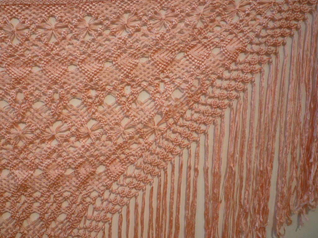 A gorgeous pink rayon ribbon macrame shawl or fischu in a triangular shape.