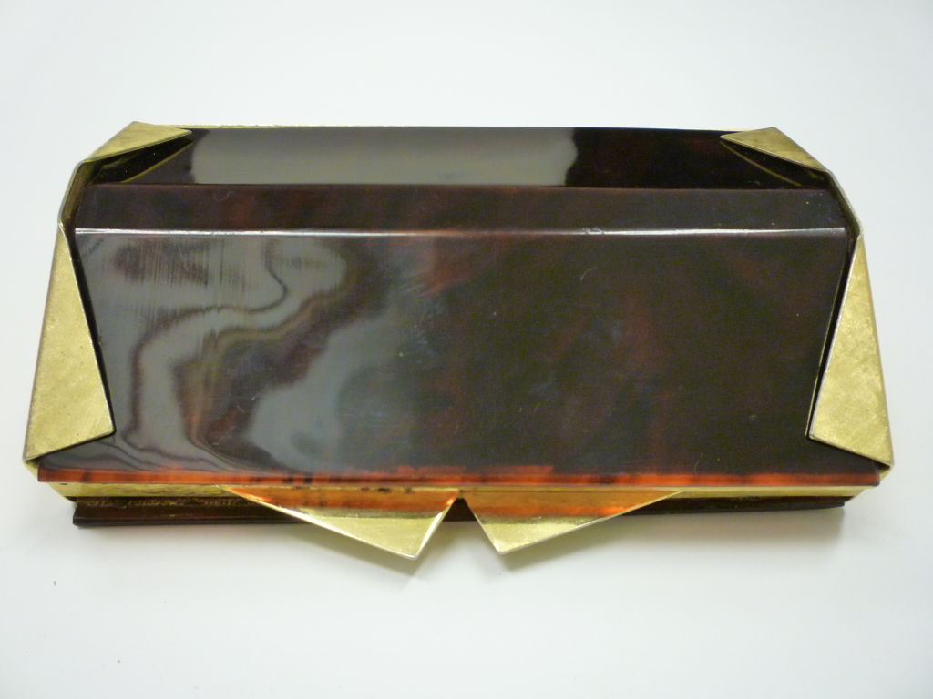 A beautiful faux tortoise lucite angular clutch made in Italy for the Rosenfeld company.  Brushed gold metal frame and convertable chain handle.  <br />
<br />
Measures: <br />
6.75