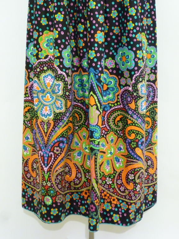 Oscar de La Renta polished cotton 1970s summer print maxi dress with vivid paisley/floral print that really pops due to the black background.  Mandarin styling of the bodice includes Nehru collar and knotted frogs and matching aqua blue piping. 