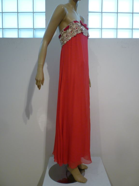 A beautiful 60s silk chiffon strapless goddess gown from Bob Bugnand for Sam Friedlander.  The bodice is covered in beaded and rhinestone encrusted heavy lace.  Inner structured bodice.  Size 4-6.