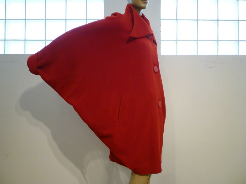 A wonderful 80s piece originally sold at Bergdorf Goodman from Alik Singer:  A vibrant wool day coat with extreme dolman sleeves, interesting long tab collar and beautiful large buttons.  All the Art Deco style from the 30s in an 80s coat!  Large