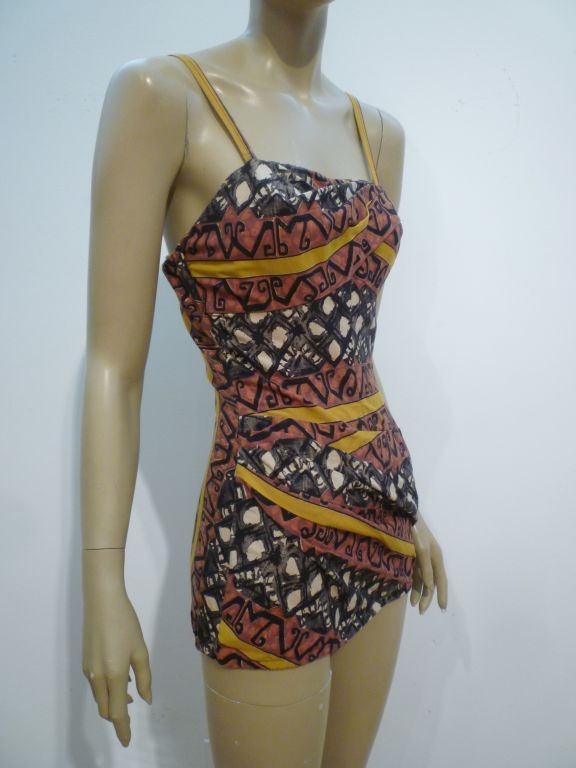 A fabulous 50s Rose-Marie Reed tiki print one-piece bathing suit with skirting.  Size 6