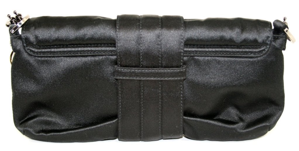 This authentic Lanvin Black Satin Clutch is in pristine condition, perhaps carried one time.  Beautifully detailed with an optional strap, this lovely piece is a wonderful addition to any collection. 
 
Black satin clutch has a roomy ten inch