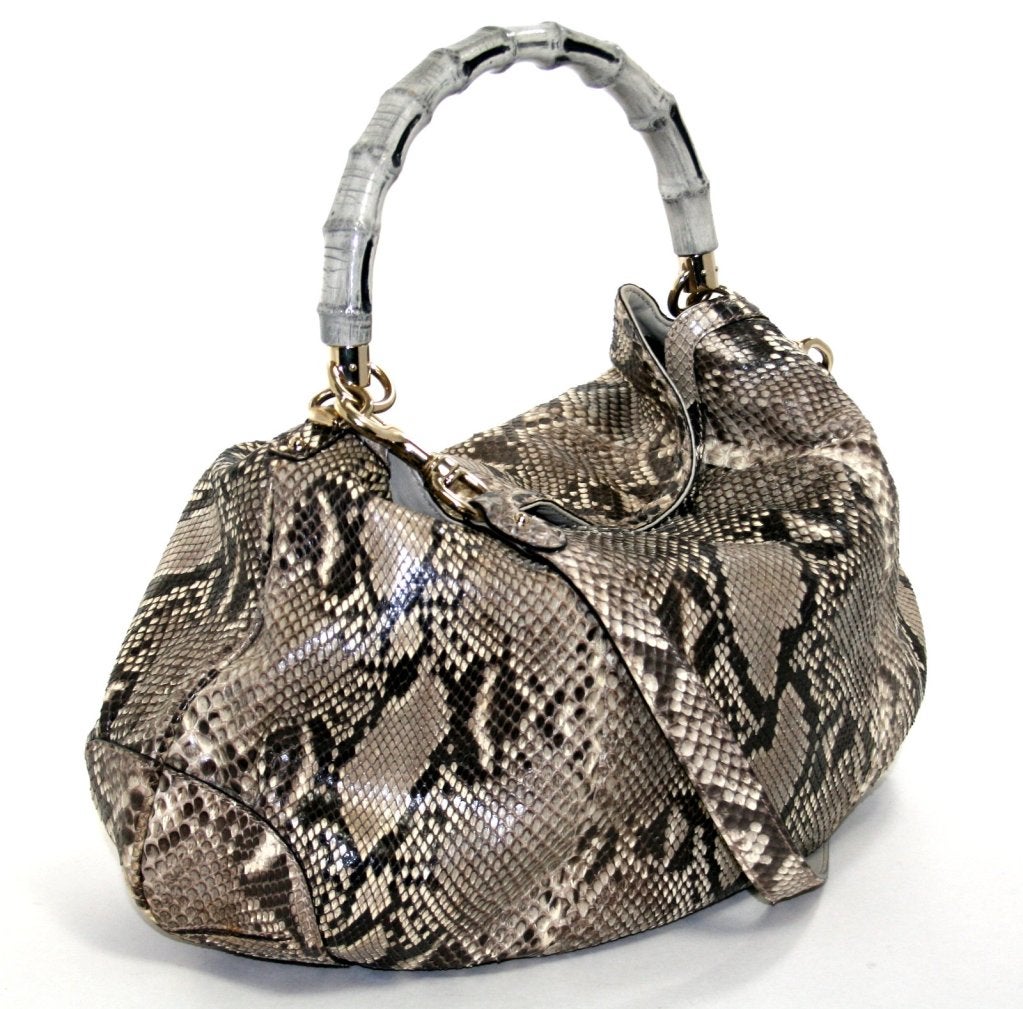 This authentic Gucci Python Peggy Hobo is an unworn former store display with the original tag still attached.  Carried by the bamboo handle or with the optional shoulder strap, this beautiful exotic is certain to hold its value. 
 
Large python