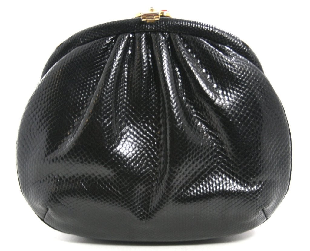 This authentic Judith Leiber Black Lizard Evening Bag is in mint condition, possibly carried only once.  A beautiful accompaniment for any evening affair.   Ms.  Leiber’s bags are frequently seen on the red carpet and are a noted favorite of first