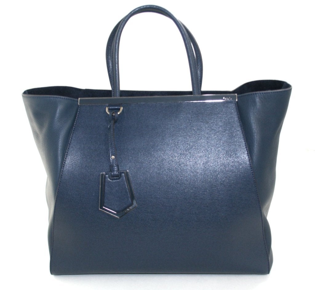 This authentic Fendi Blue Leather 2Jours Large Shopper has never been carried and is in pristine condition. The classic silhouette is a current style and a must have for any sophisticated wardrobe.  Retail price $2,450.00.
 
Cobalt blue tote is