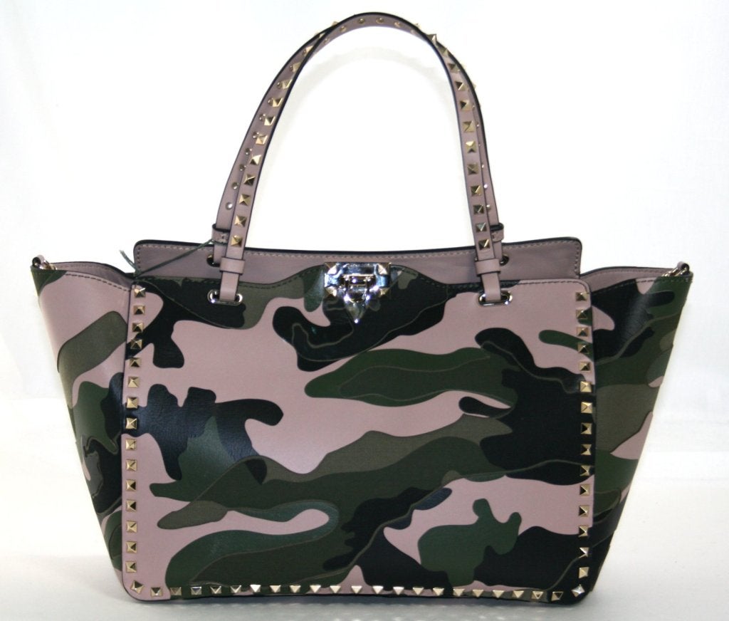 This authentic Valentino Camouflage Rock Stud Tote is brand new and has just hit the stores for spring.  Uniquely designed in a combination of leather and canvas with soft pink mixed among the classic camo pattern, this edgy tote is perfect for