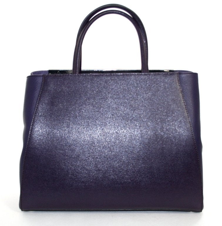 This authentic Fendi Amethyst Leather 2Jours Elite Shopper has never been carried and still has the protective plastic still intact on the hardware.  The classic silhouette is a current style and a must have for any sophisticated wardrobe. 
 
Deep