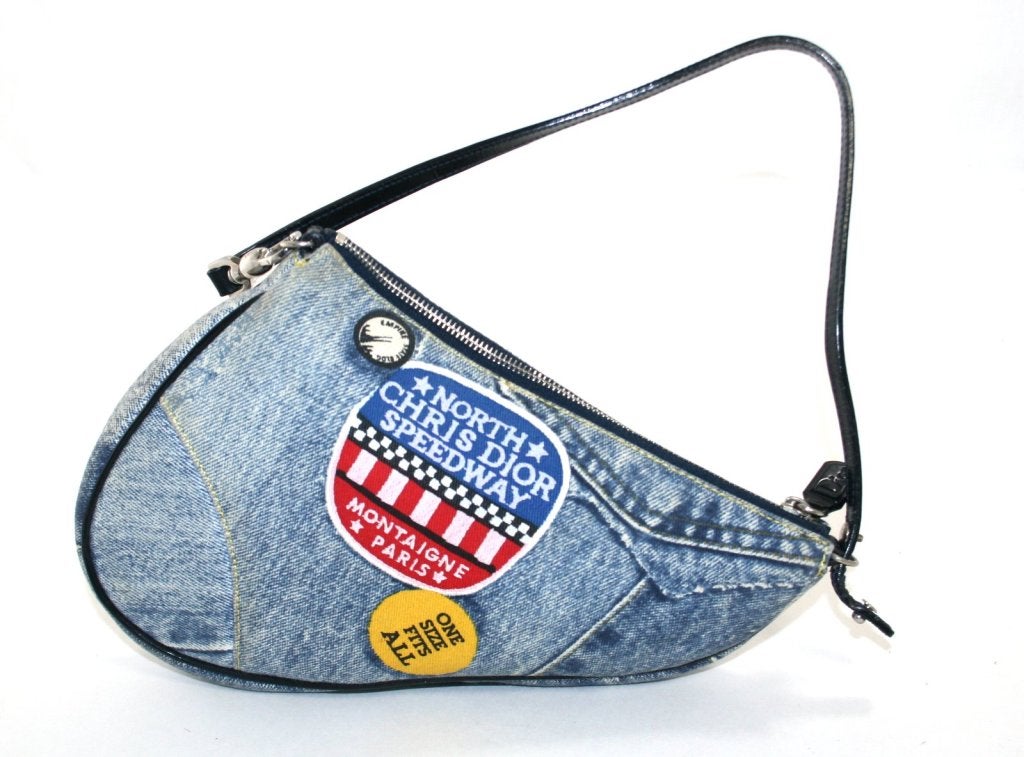This authentic Christian Dior Denim Mini Saddle Bag is in excellent condition with minimal signs of prior ownership.  The whimsical patchwork design is flirty and fun and makes this Dior an adorable addition to any collection.  Estimated current