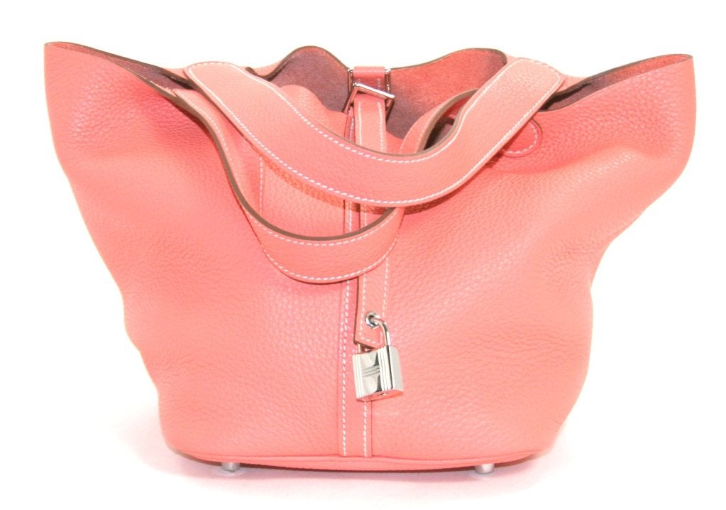 This authentic Hermès Crevette Clemence Leather Picotin MM is in pristine unworn condition.  The understated chic style is perfect for daily enjoyment in a pretty salmon pink that hits all the right marks for spring. 
 
The Picotin is simply