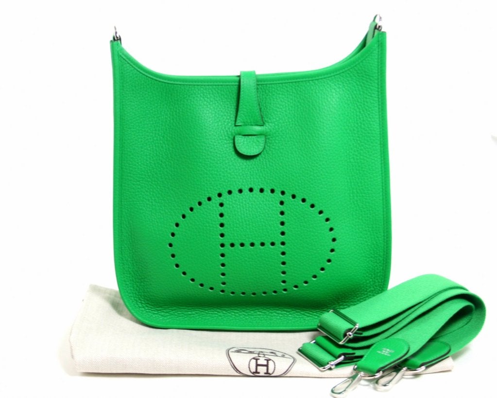 Pristine and never carried, this Evelyne III PM in the newest shade of green from Hermes is breathtaking. Known as Bambou, the 2014 green is the color of a perfectly manicured lawn on a sunny day.

The Evelyne silhouette is inspired by the tool