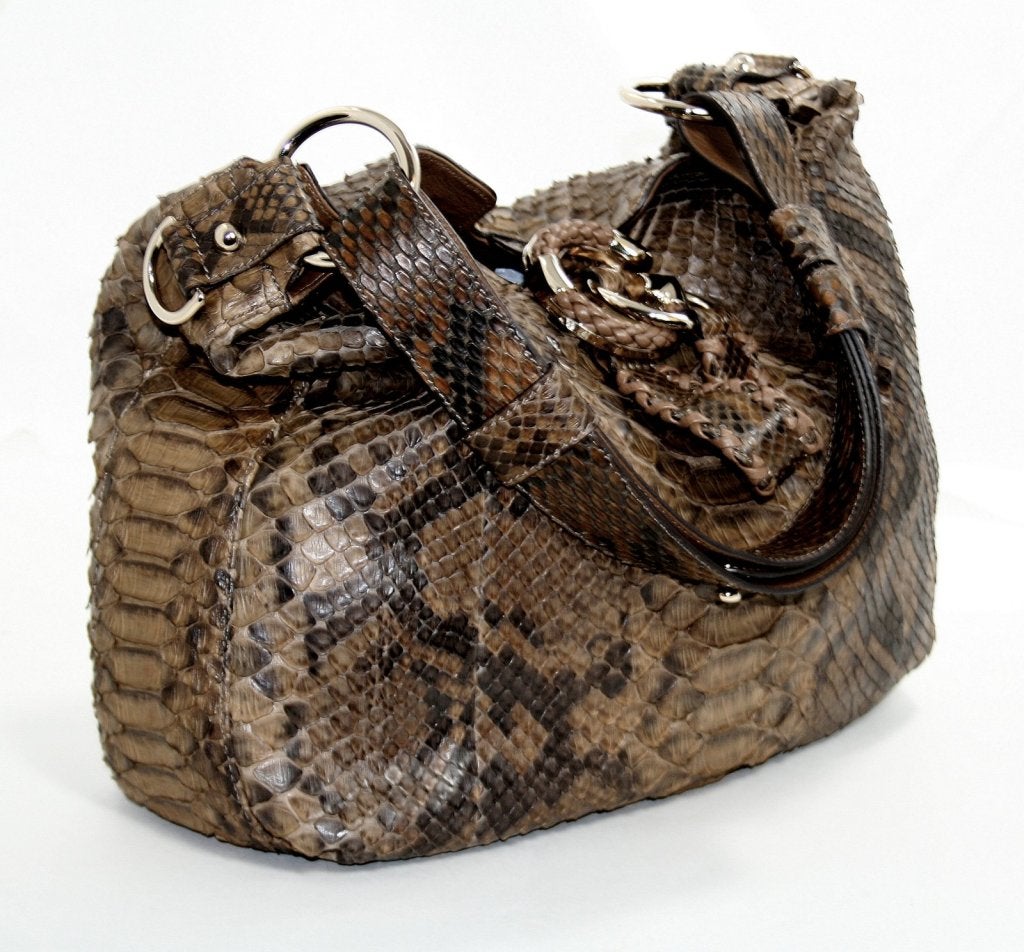 This Authentic Gucci Python Hobo is in truly mint condition with no significant signs of prior ownership.  A must have for exotic lovers; this skin has every shade of neutral brown and has a timeless appeal.
 
Large hobo silhouette in varying