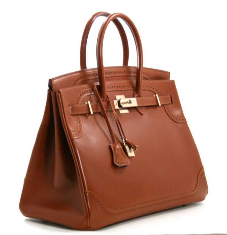 This authentic Hermès Ghillies 35 cm Birkin is pristine with the protective plastic intact on the hardware. Some very minor hairline scratches exist on the leather due to the delicate nature of Tadelakt, but this bag has never been carried.  It has