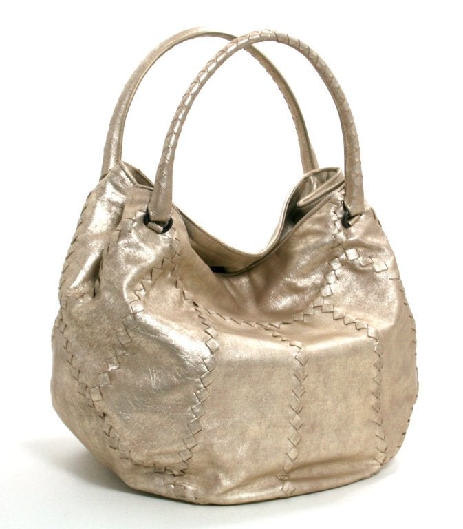 This Authentic Bottega Veneta Metallic Mineral Hobo is in mint condition.  There is a very small area of glue migration along the top edge. Please review photographs.   The corners, handles and interior are pristine. 
 
Distressed metallic gold