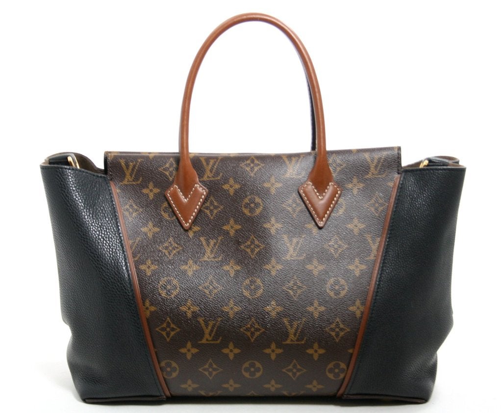 This Authentic Louis Vuitton Monogram W PM Tote in Noir is in mint condition with only very minor signs of prior ownership on the interior.  The sophisticated style carries everything with ease for chic daily use in any circumstance.  Wildly
