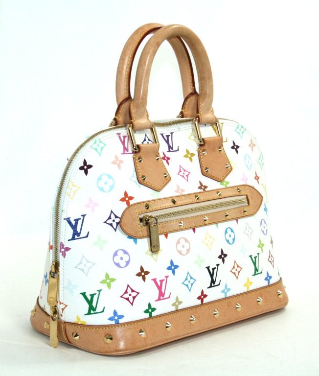 This Authentic Louis Vuitton White Multicolore Canvas Alma PM is in beautiful overall condition.  The exterior canvas and interior are truly excellent.  There are watermarks on all the cowhide areas which include the bottom, handles and trimmings. 