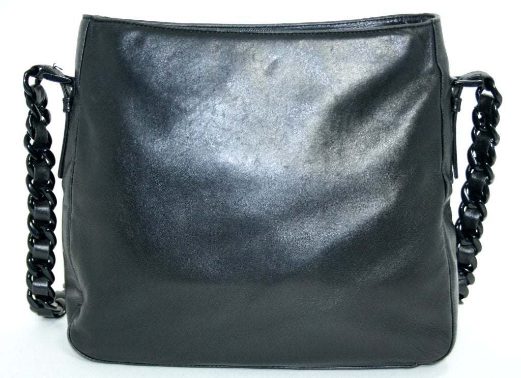 This Authentic Prada Black Leather Resin Chain Bag is in mint condition with only very subtle sings of prior ownership.  An elegant medium sized bag that can go anywhere in always desirable black with black resin accents. 
 
Sublimely soft smooth