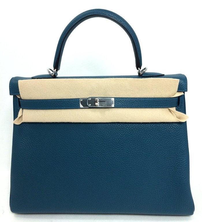 This Authentic Hermès Colvert Clemence 35 cm Kelly is in pristine unworn condition with the plastic intact on the hardware.   Hermès bags are considered the ultimate luxury item worldwide.  Each piece is handcrafted with waitlists that can exceed a
