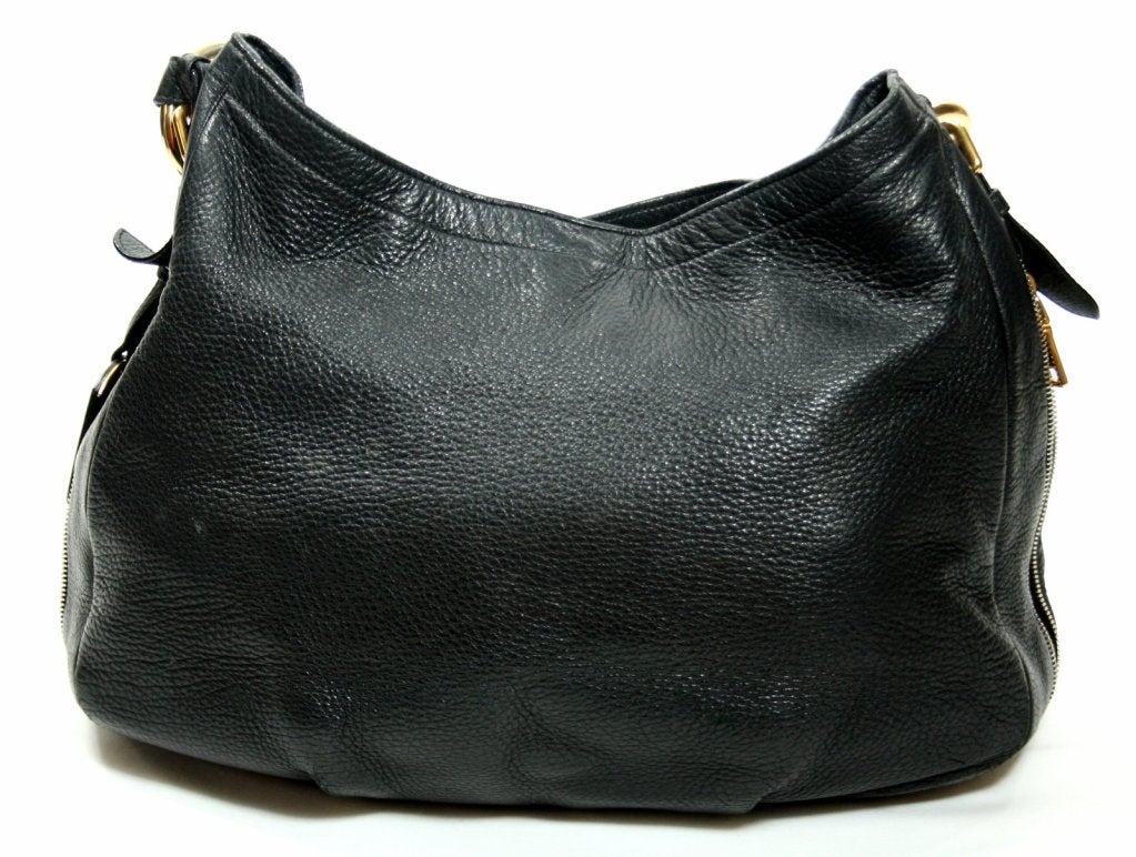 This Authentic Prada Black Leather Zip Around Hobo is in very good condition with only some small areas of wear.  There is light corner and handle wear consistent with gentle use on a previously owned item.  There is also a small area of wear on the