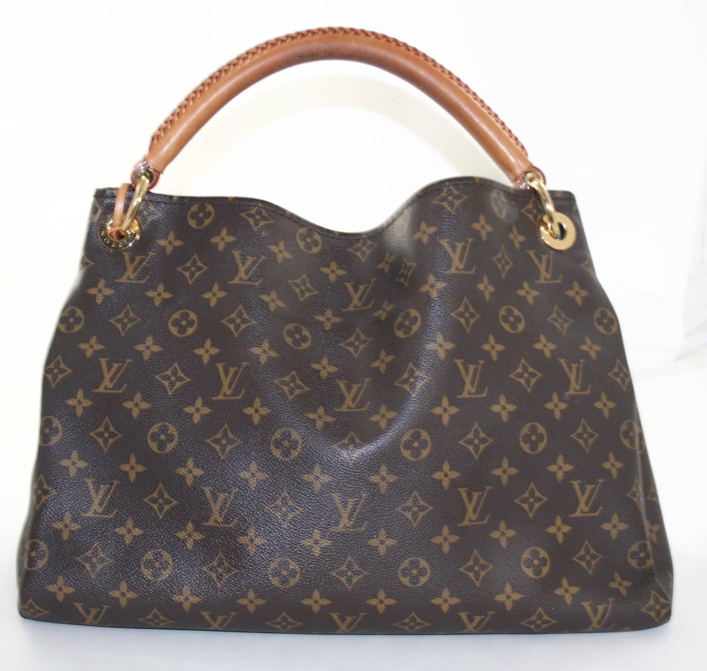This authentic Louis Vuitton Monogram Artsy MM is in very good condition with signs of wear on the handle and ink marks on the inside of the interior pocket. The current style is wildly coveted and retails for over $1,780.00 with taxes. 
