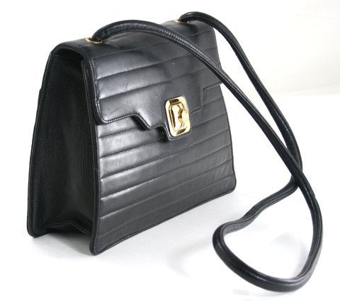 This authentic Chanel Black Lambskin Kelly Style Shoulder Bag is in excellent condition.  There is light scratching on the exterior due to the extremely soft nature of lambskin and subtle wear to the corners.  The interior is in mint condition. 