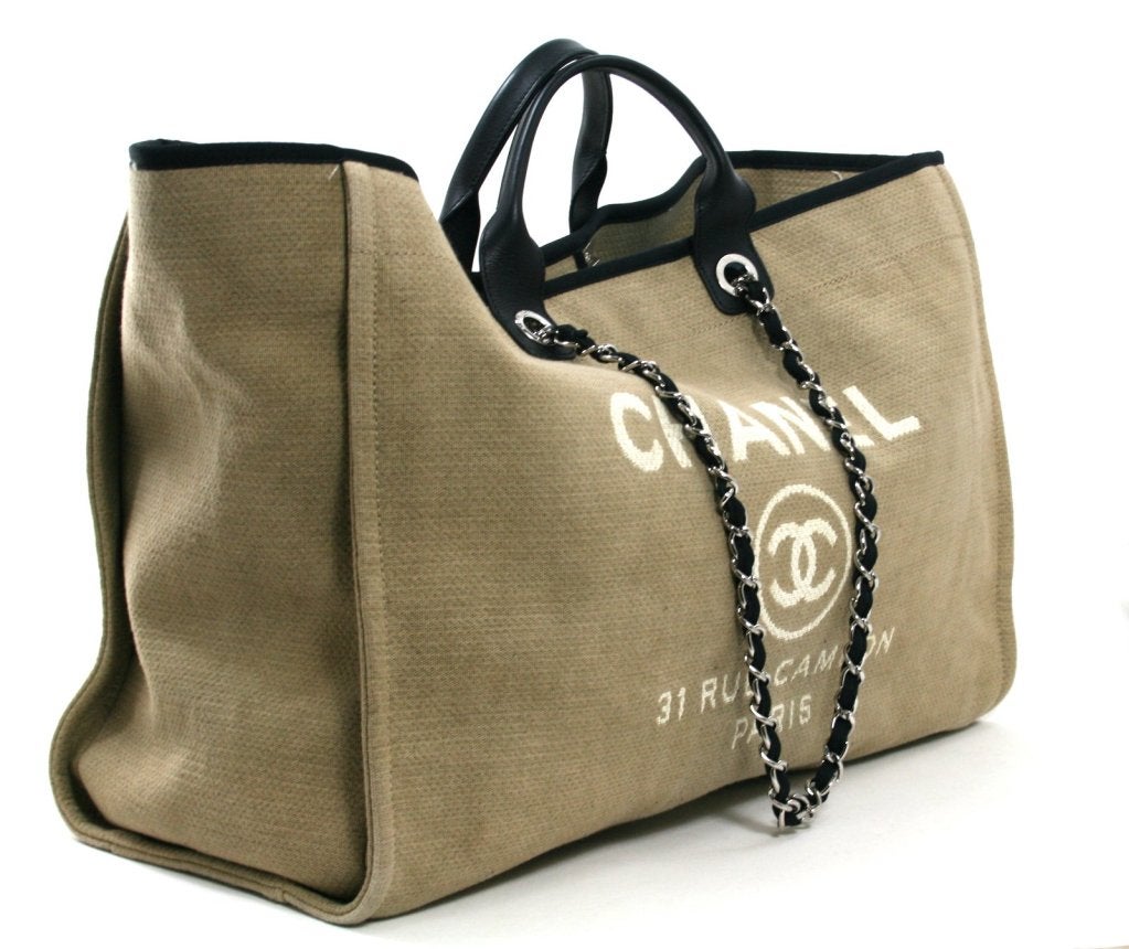 This authentic Chanel Tan Canvas XL Cambon Tote is in mint condition with minimal signs of prior ownership.  The oversized bag is perfect for a variety of uses including travel, professional use or chic beach wear. 
 
Khaki tan canvas is trimmed