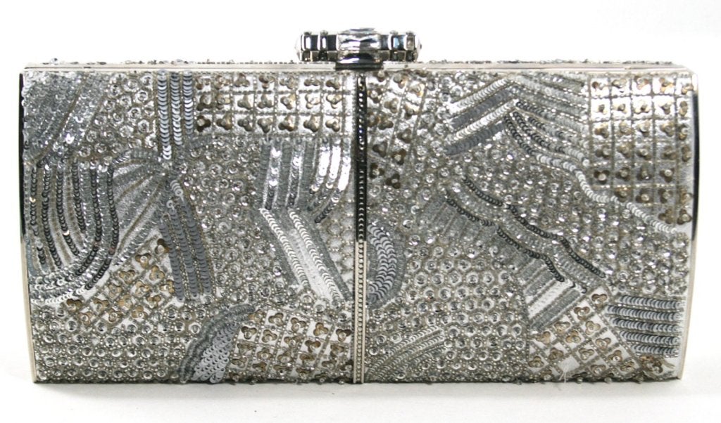 This authentic Judith Leiber Silver Crystal Clutch is in truly excellent condition.  Believed to have been carried one time, there are a few beads missing though it is nearly impossible to notice.  Exquisitely adorned with crystals, sequins and