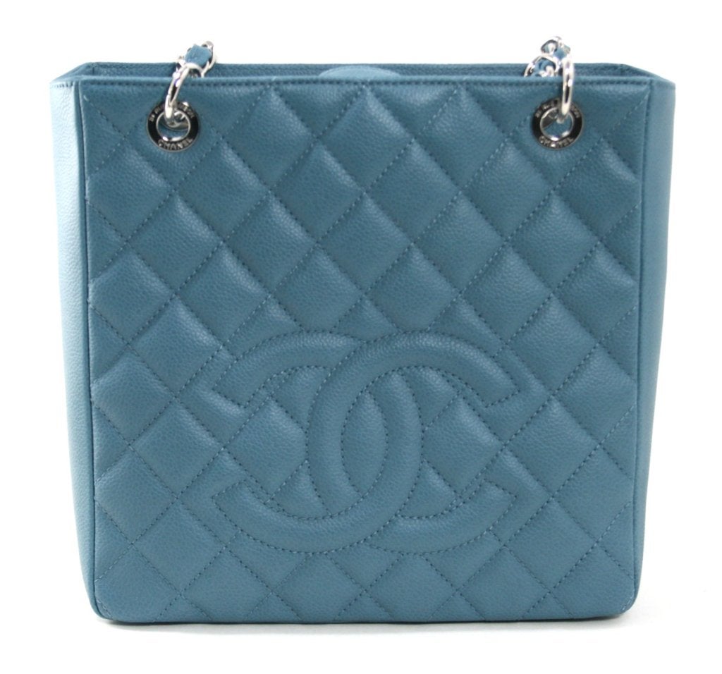 This authentic Chanel Blue Caviar PST is in pristine unworn condition with the tag still attached. Part of the classics collection, the PST, or Petite Timeless Tote, is particularly unique in a stunning shade of denim blue. 
 
 Durable and scratch