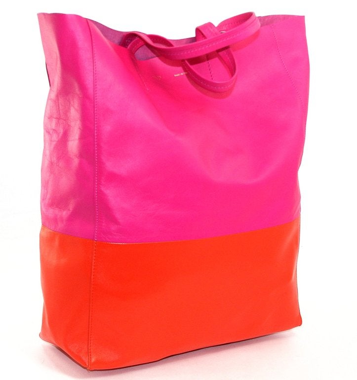 This authentic Celine Bi Cabas Tote in Fluo Pink and Orange is brand new.  Fluo Pink has been wildly popular throughout the collection.  Paired with vivid orange, the color blocked style is both casual and sophisticated at the same time. 
 
Nearly