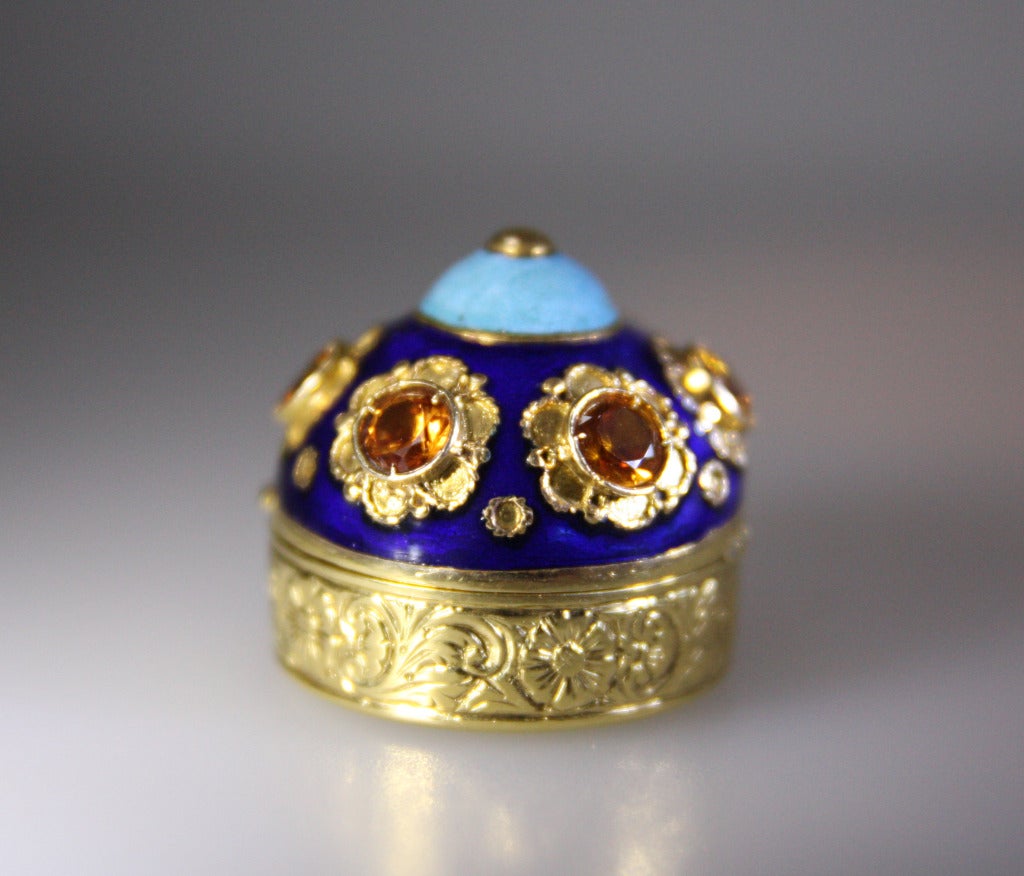 Pill box has light and dark blue enamel and is further set with 
Topaz on the top.