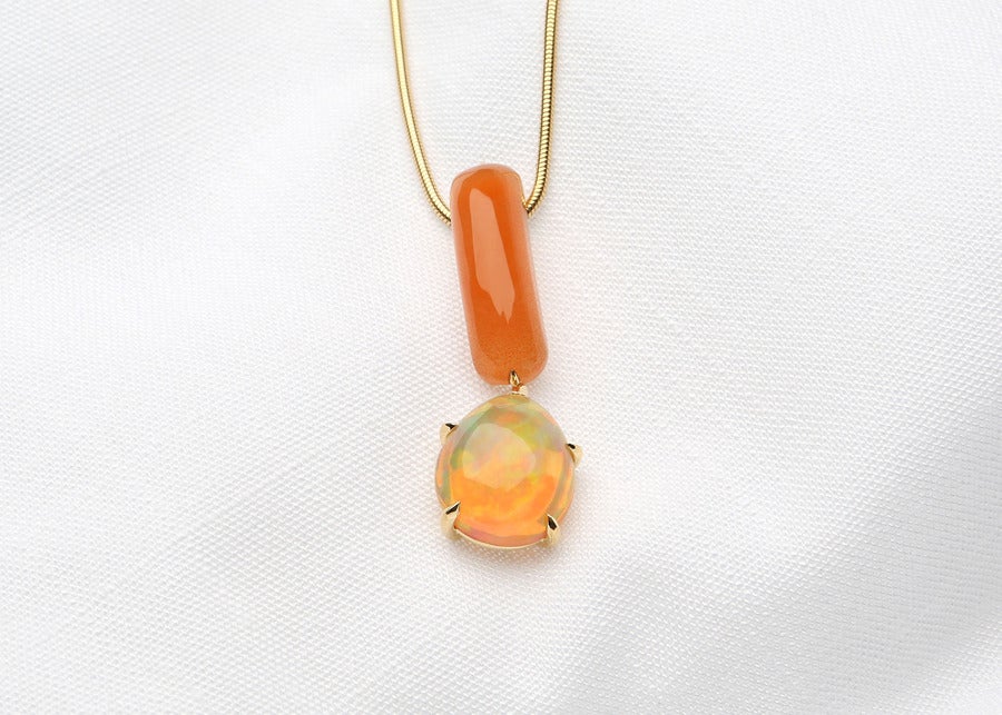 This opal shows big patches of orange and green.  Attached below a custom cut piece of orange chalcedony, sliding on a silky smooth snake chain.  Designed by David Precious Gems.