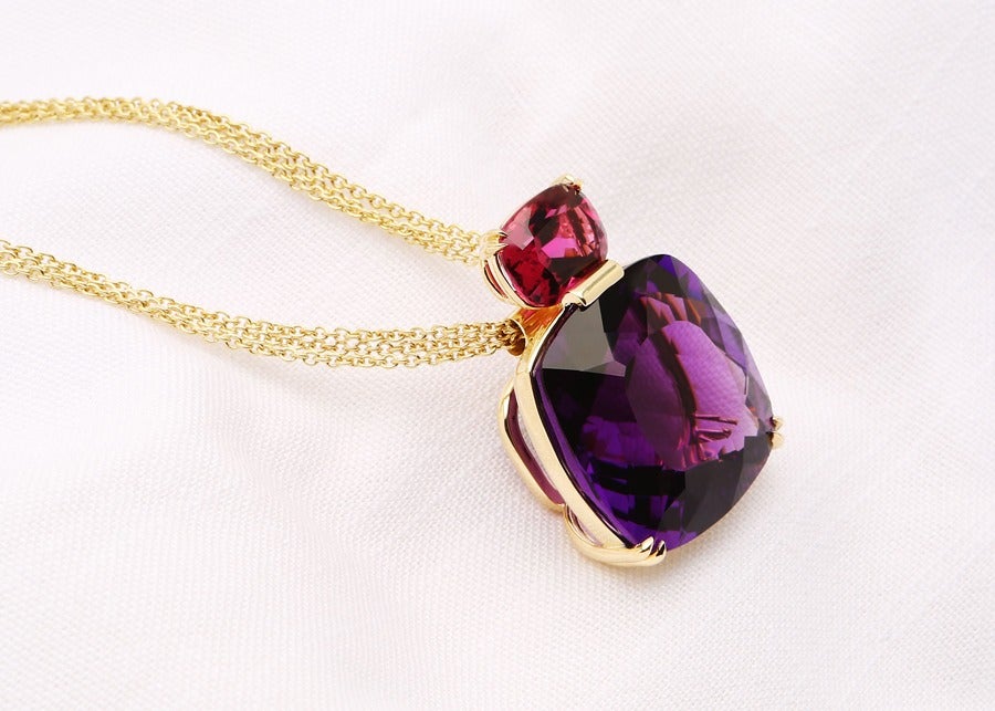 David Precious Gems one of a kind pendant featuring a cushion cut 63 carat amethyst and a vivid rubellite, suspended from a triple strand chain.