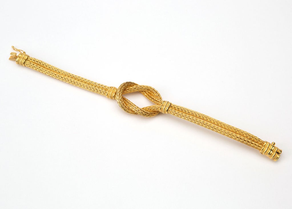 Rich flexible woven gold finished with a dramatic knot.  Wearable elegance.