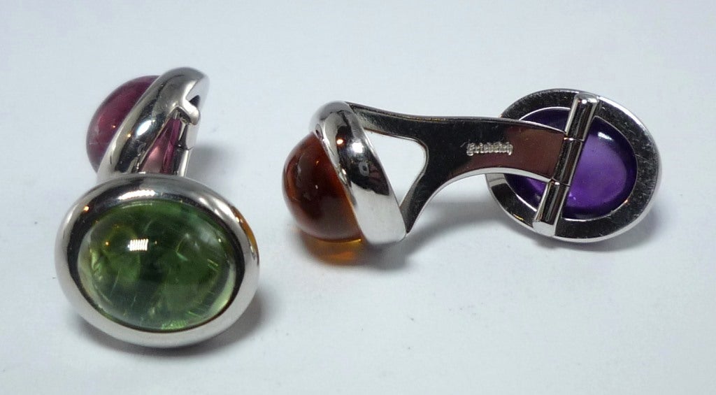 Beautifully Handcrafted Cuff links with solid Links and Hinges for extra convenience, 
4 Cabochons: Amethyst, Madeira-Citrine, Tourmaline, Rubelite
Total of 11,87 cts.
All in 750/- White Gold.