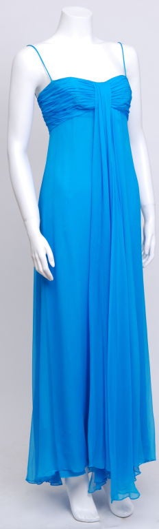 Blue silk chiffon gown.Rouched bust, spaghetti straps, empire waist, fully lined with flowing layers of chiffon.