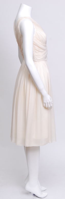 Inspired by the Ceil Chapman dress designed for Marilyn Monroe in the film Seven Year Itch. Rouched ivory silk chiffon cocktail dress with a plunging neckline.