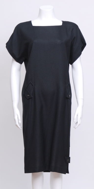 Pierre Cardin black linen day dress with two front snap closure pockets. Back and side detail with snap closures. Dress falls just below the knee.