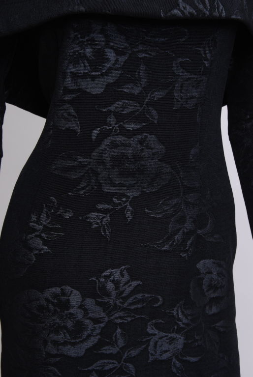 Stretchy, tightly knit, off the shoulder, floral black on  black brocade dress. Exxagerated neckline folds over to form a capelet. Very flattering scoop back and straighter neckline.<br />
<br />
<br />
June Carter was a distinguished singer,