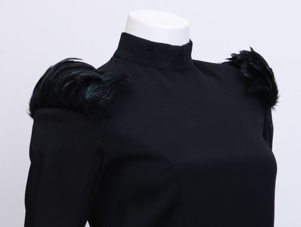 Very unique Rifat Ozbek dress with attached gloves and trimmed in black iridescent feathers at shoulders.<br />
Mock neckline with zippered back and wrists.<br />
Long arms with a glove size 7.5-8.5.