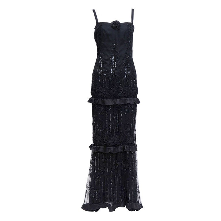Valentino black silk gown with 20's style detailed sequin net overlay. Accented with a silk rose and three light ruffles.<br />
<br />
Born Valentino Garavani,Valentino’s international debut took place in 1962 in Florence, the Italian fashion