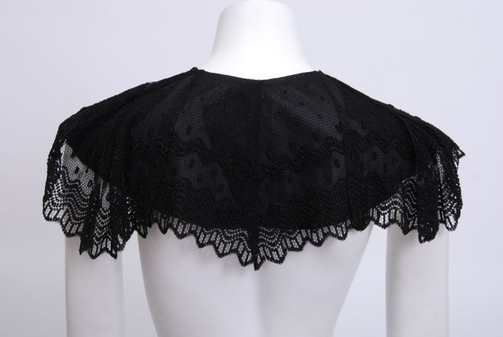 Silk lace caplet style collar with toggle closure.