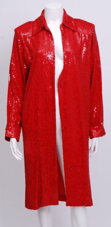 Bright red silk jersey and sequin shirt-dress with snap closures and a tie belt. The plunging neckline can be worn lower or higher and fastens  with a hook and eye closure. A classic, sexy, comfy party dress.<br />
<br />
fits a size 8-10
